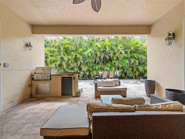 a view of a patio with table and chairs