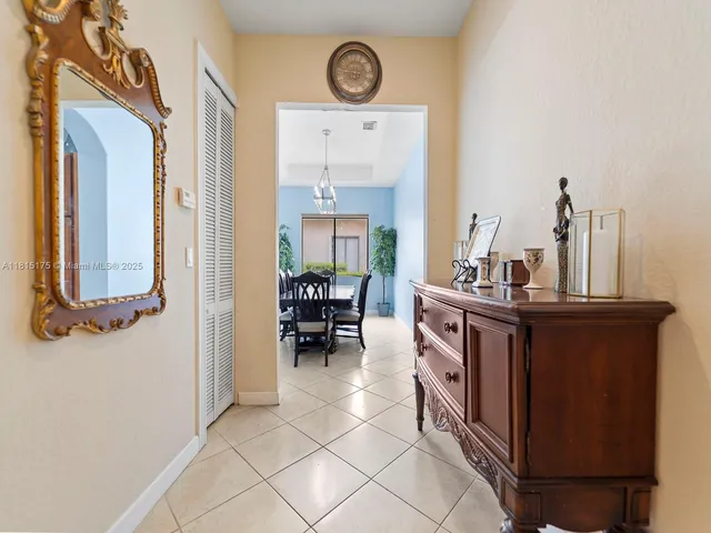 a view of living room with furniture and a clock