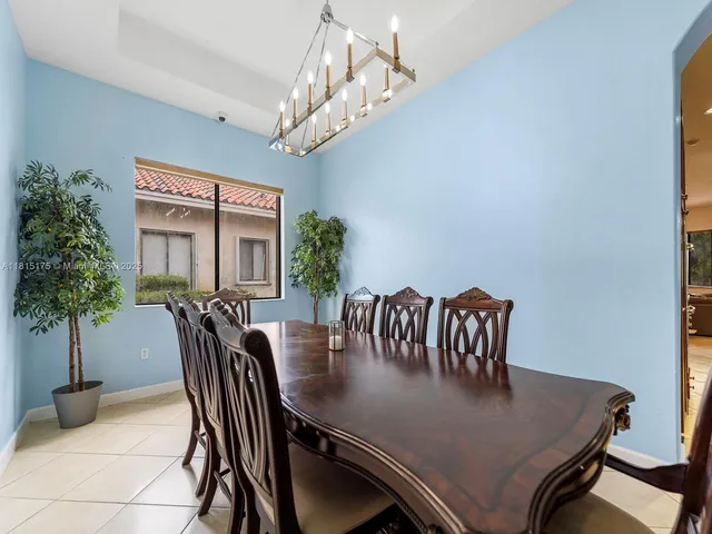 a view of a dining room with furniture and chandelier