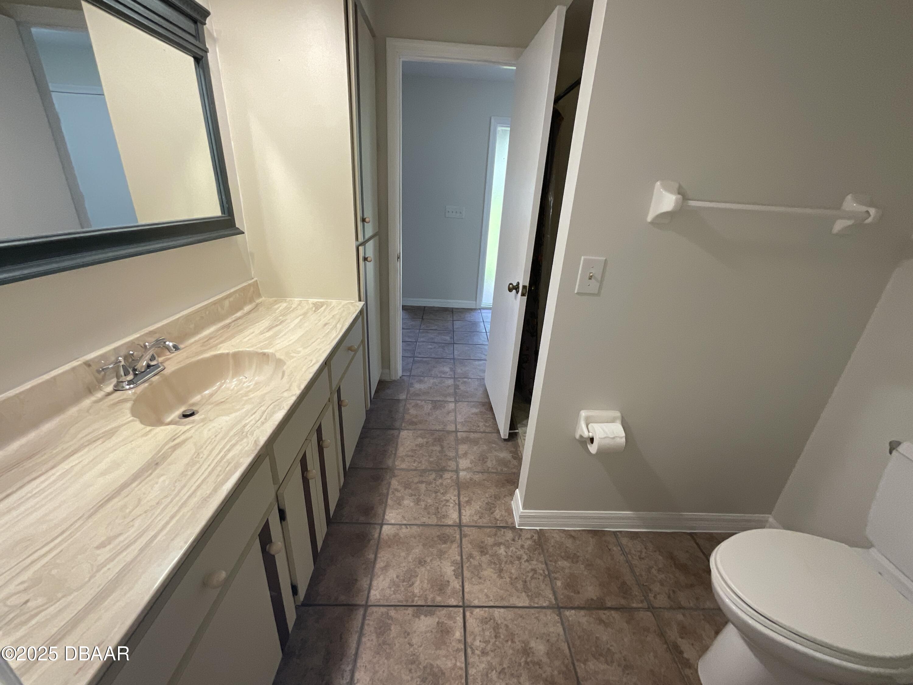 8 Ridge Trail Ormond Beach, FL 32174 - Photo 12 of 24 a bathroom with a sink a toilet a mirror and shower