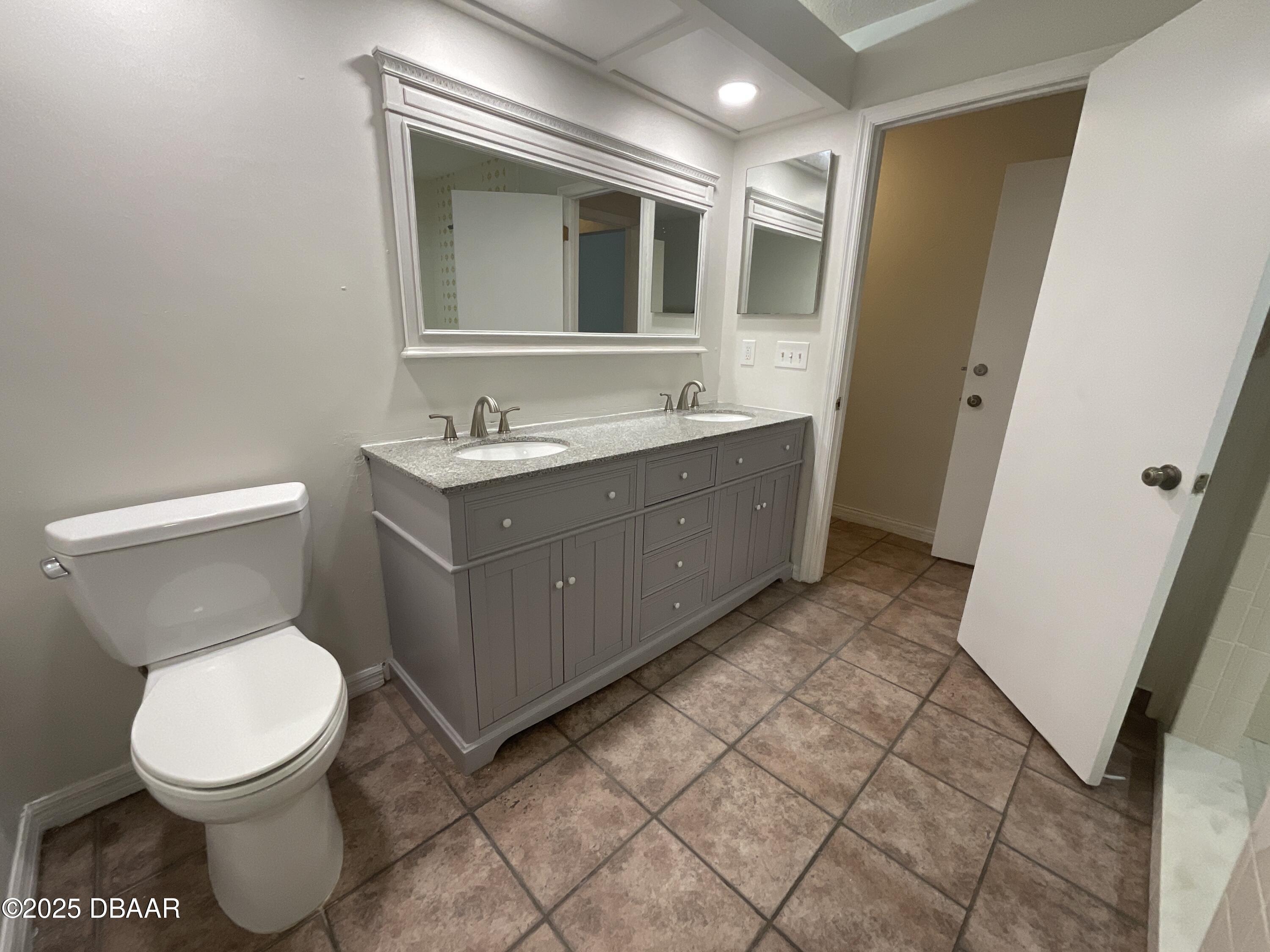 8 Ridge Trail Ormond Beach, FL 32174 - Photo 19 of 24 a bathroom with a toilet sink and mirror
