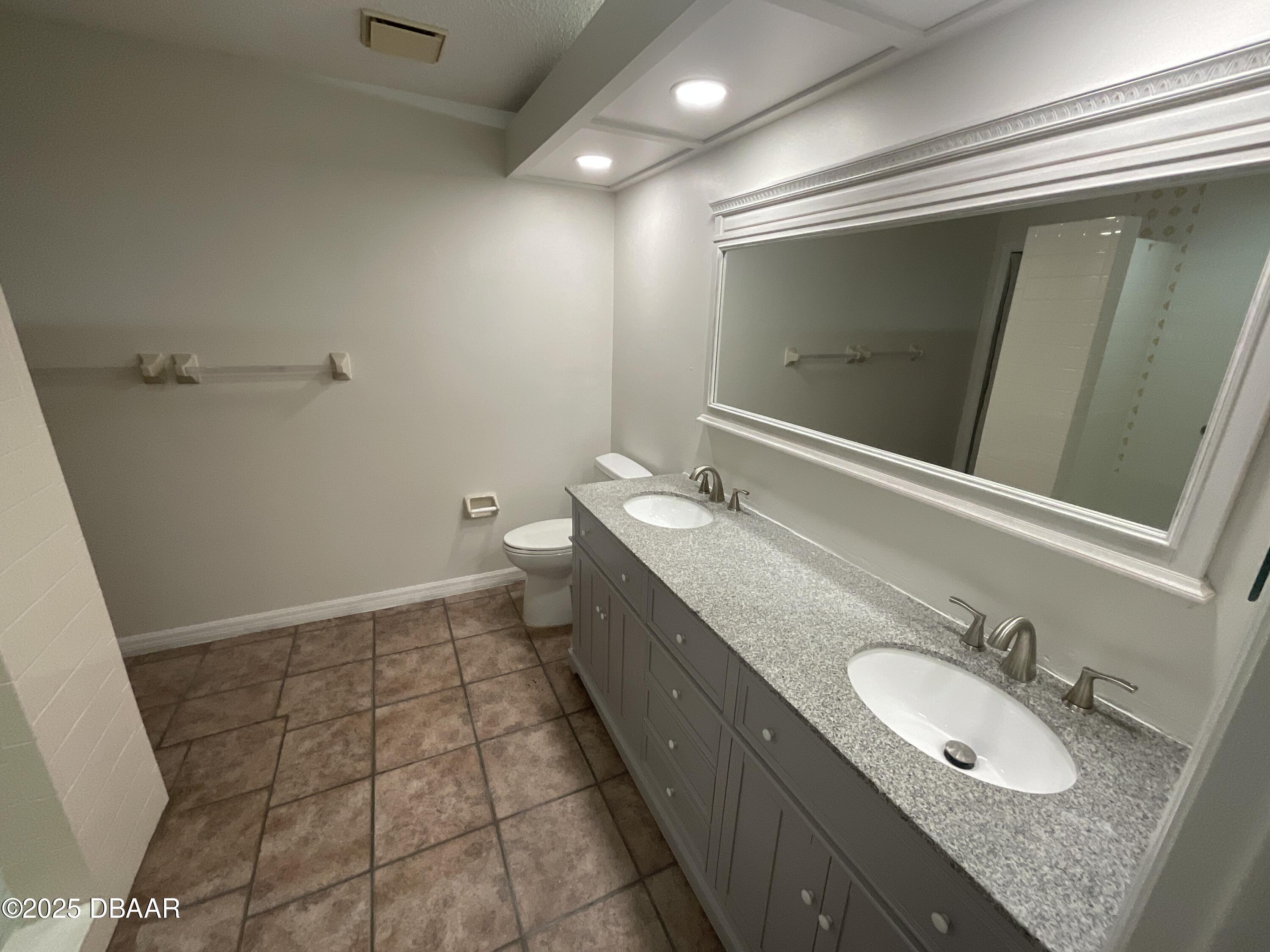 8 Ridge Trail Ormond Beach, FL 32174 - Photo 20 of 24 a bathroom with a granite countertop sink a mirror and a toilet