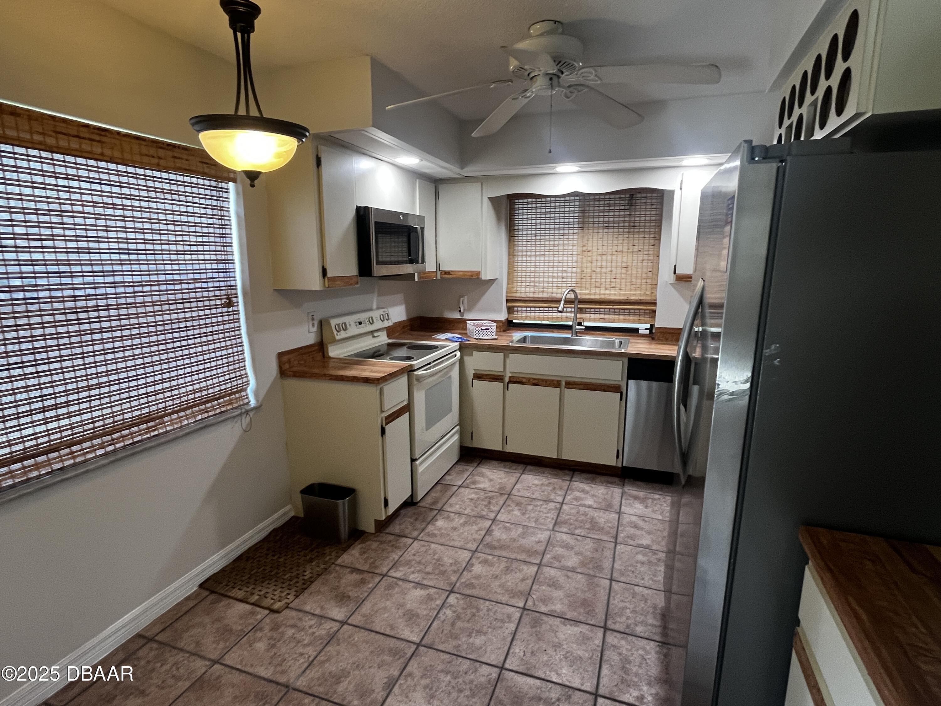 8 Ridge Trail Ormond Beach, FL 32174 - Photo 21 of 24 a kitchen with a sink appliances and cabinets