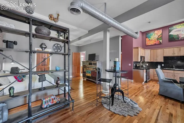 a living room with lots of furniture and kitchen view