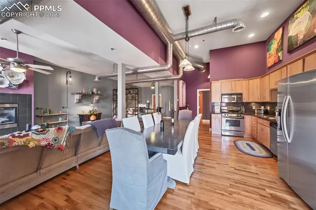 a view of a dining room with furniture a chandelier and wooden floor
