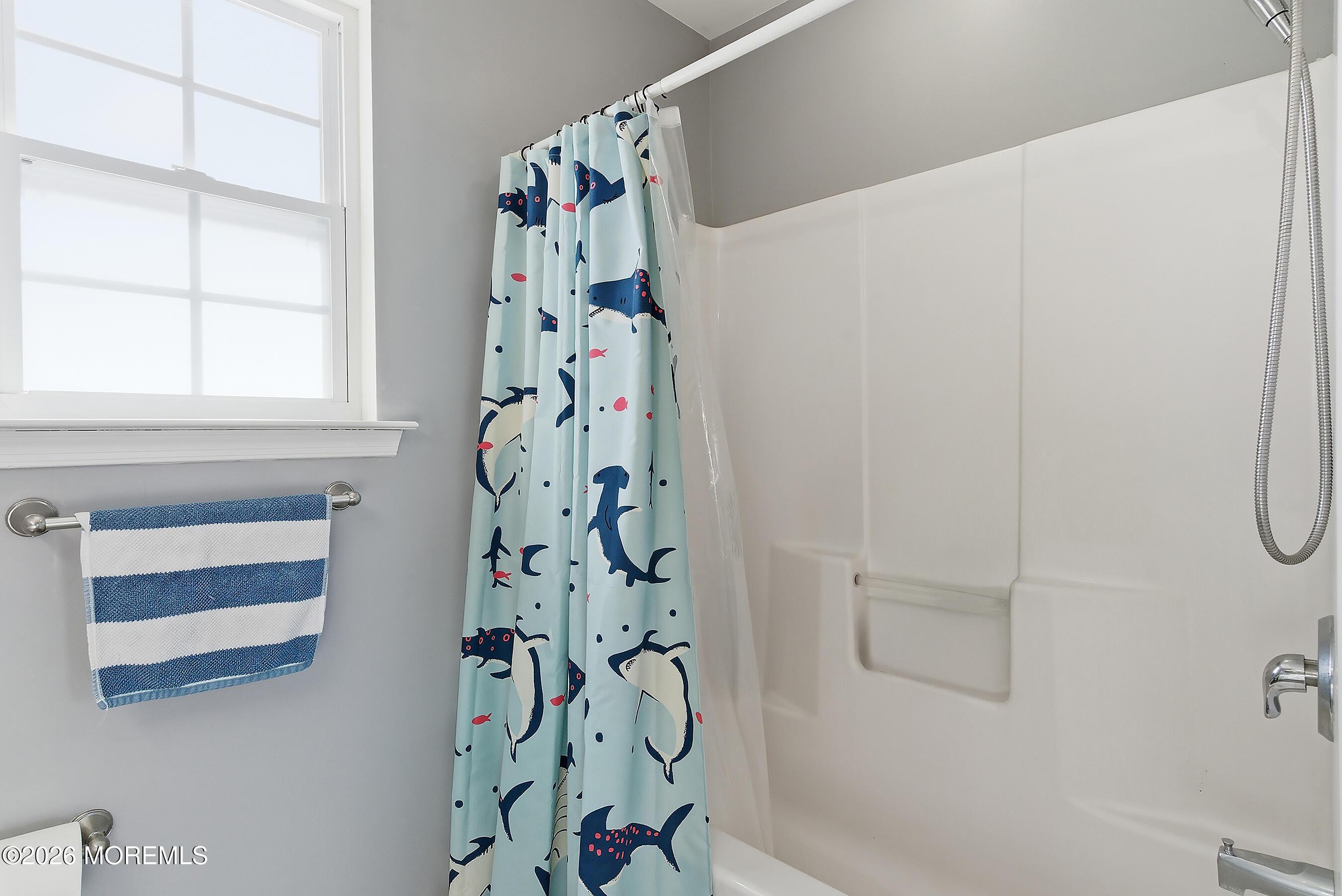 197 Inlet Avenue Manahawkin, NJ 08050 - Photo 32 of 36 a bathroom with a shower curtain and a window