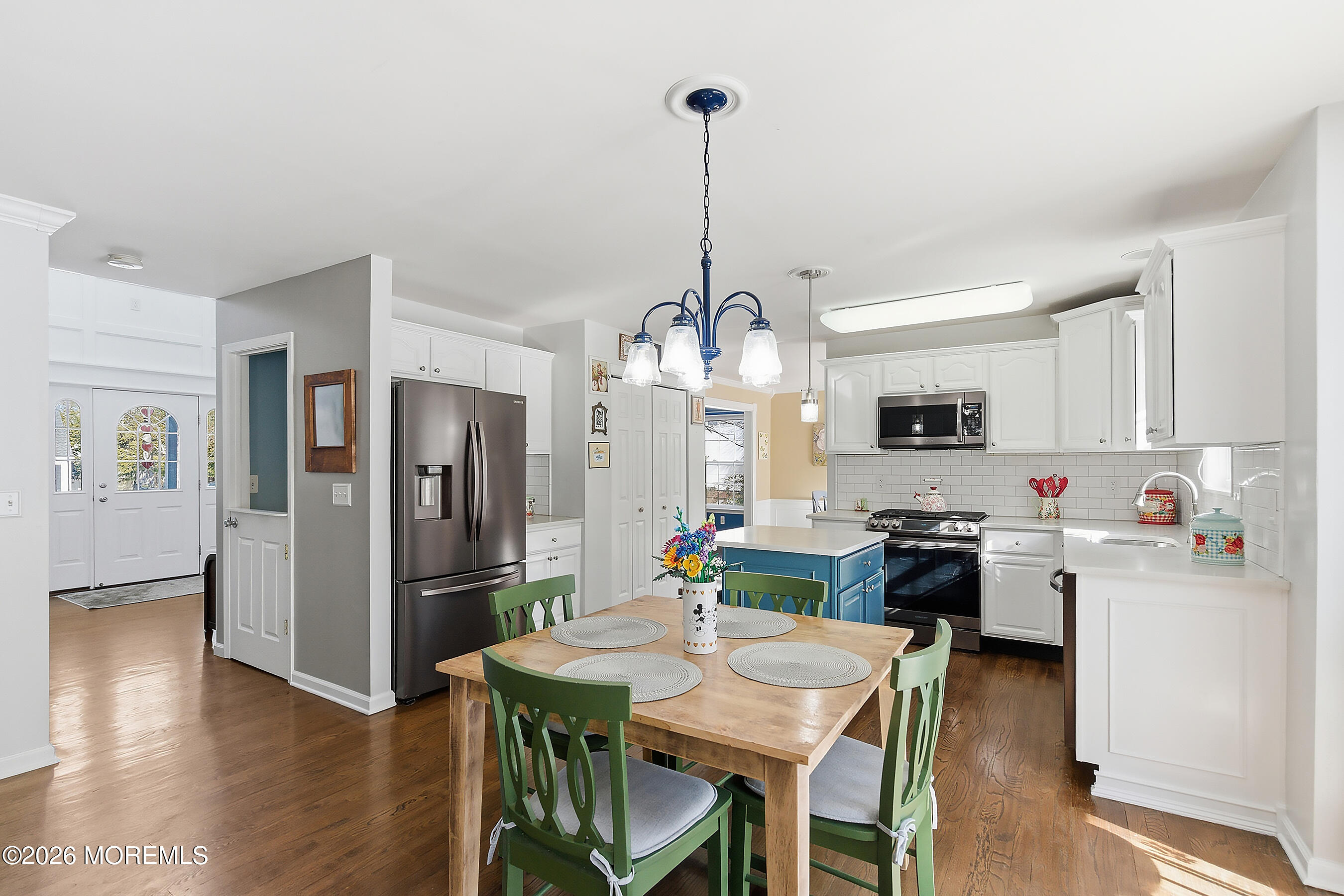 197 Inlet Avenue Manahawkin, NJ 08050 - Photo 9 of 36 a kitchen with stainless steel appliances kitchen island granite countertop a refrigerator a stove top oven a sink dishwasher and a dining table with wooden floor