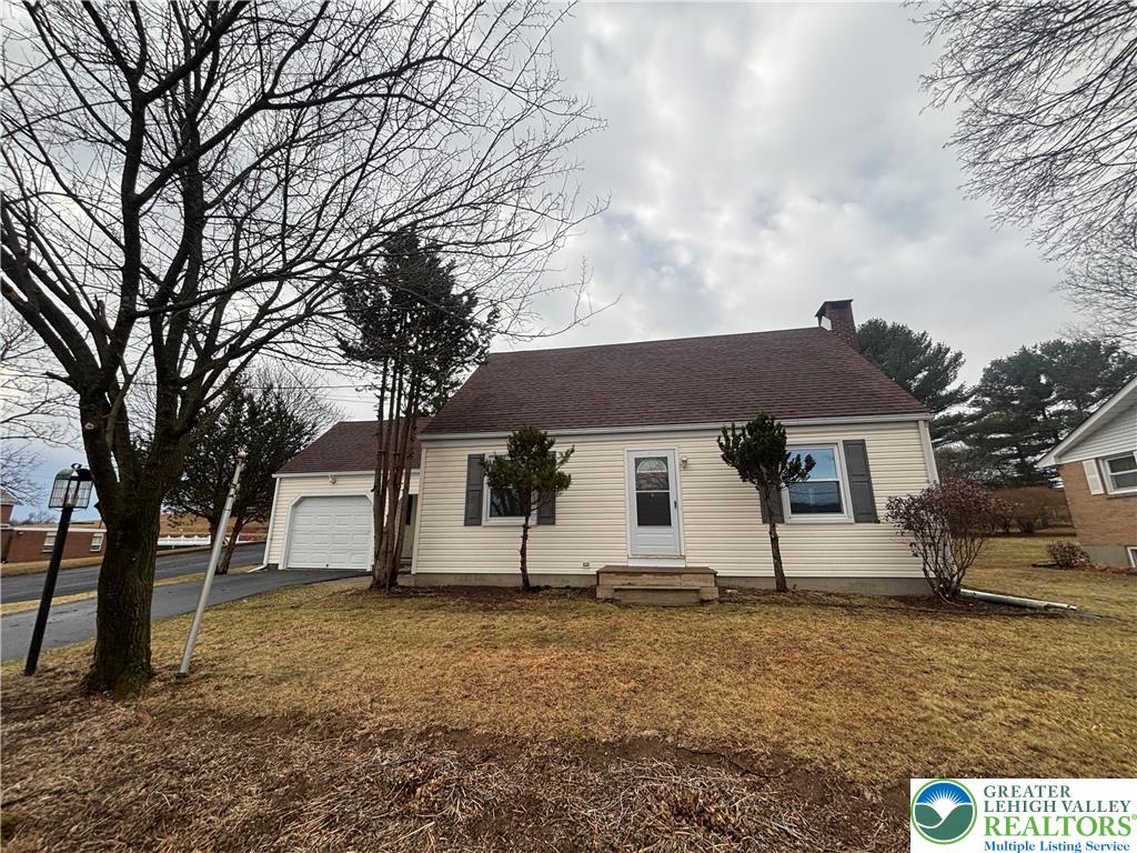 a house that has a tree in front of it
