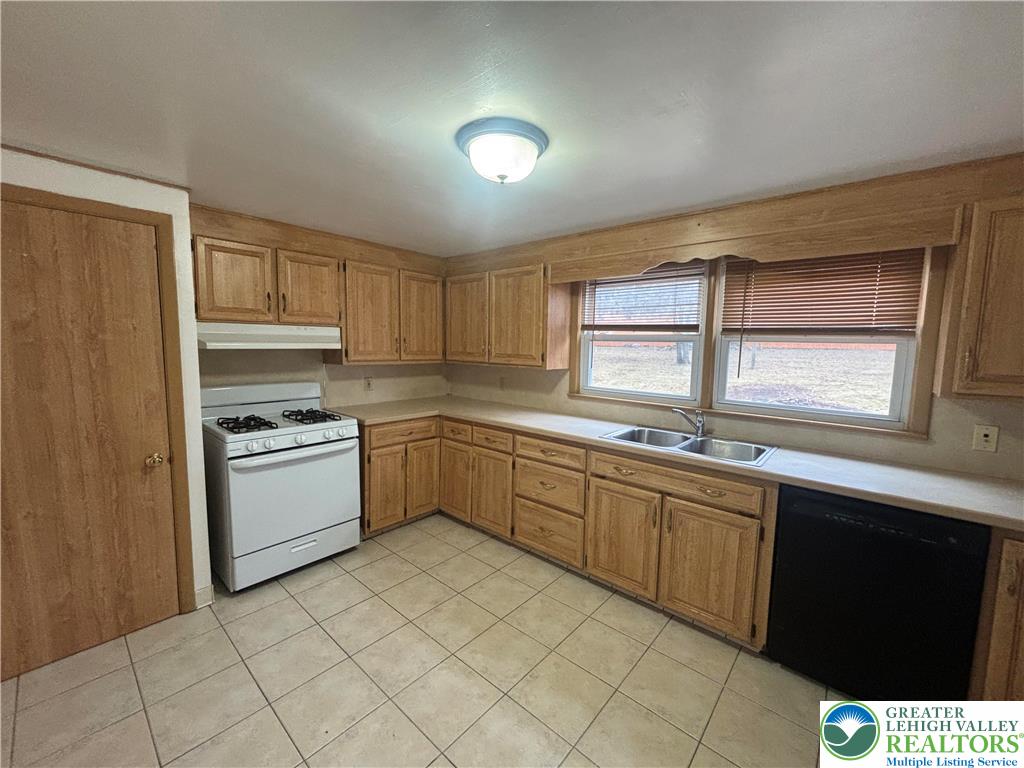257 East 2nd Street Wind Gap, PA 18091 - Photo 3 of 14 a kitchen with a sink window and cabinets