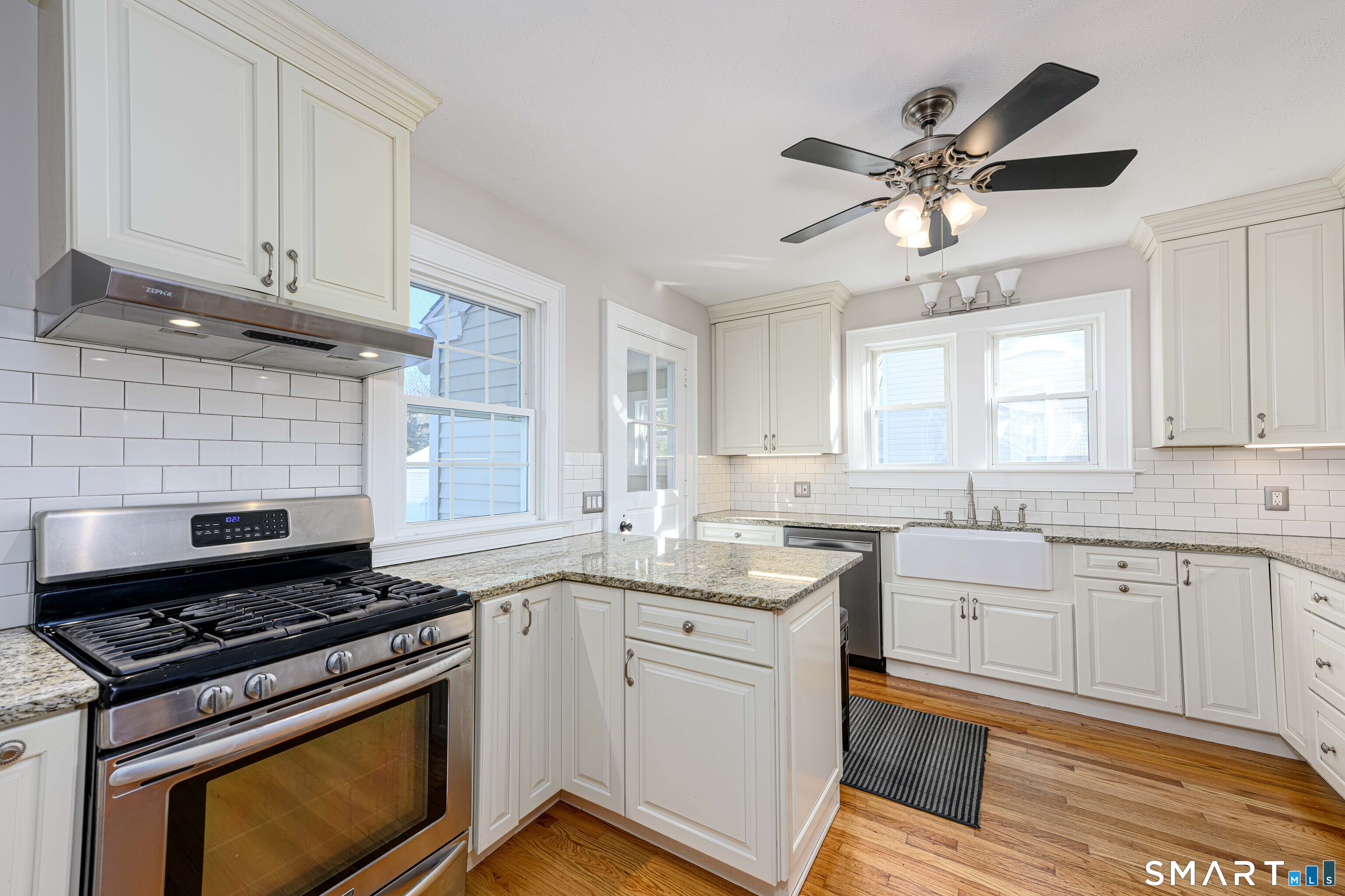 18 Day Spring Avenue Hamden, CT 06518 - Photo 15 of 35 Fully renovated kitchen with period appropriate finishes; subway tile, bib sink, creamy white cabinets, granite countertops.
