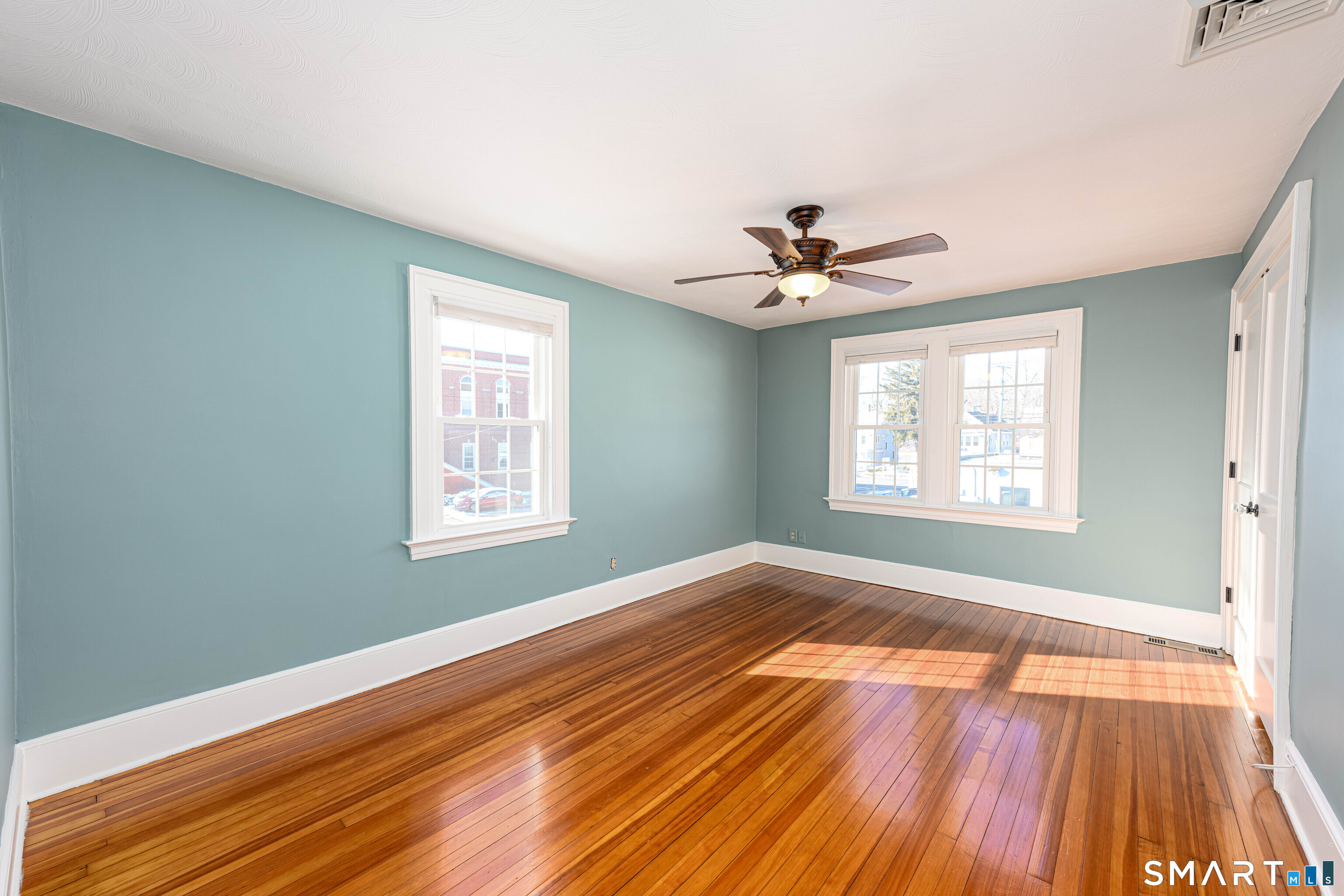 18 Day Spring Avenue Hamden, CT 06518 - Photo 20 of 35 Spacious primary bedroom, windows with two exposures lets light stream into the space.