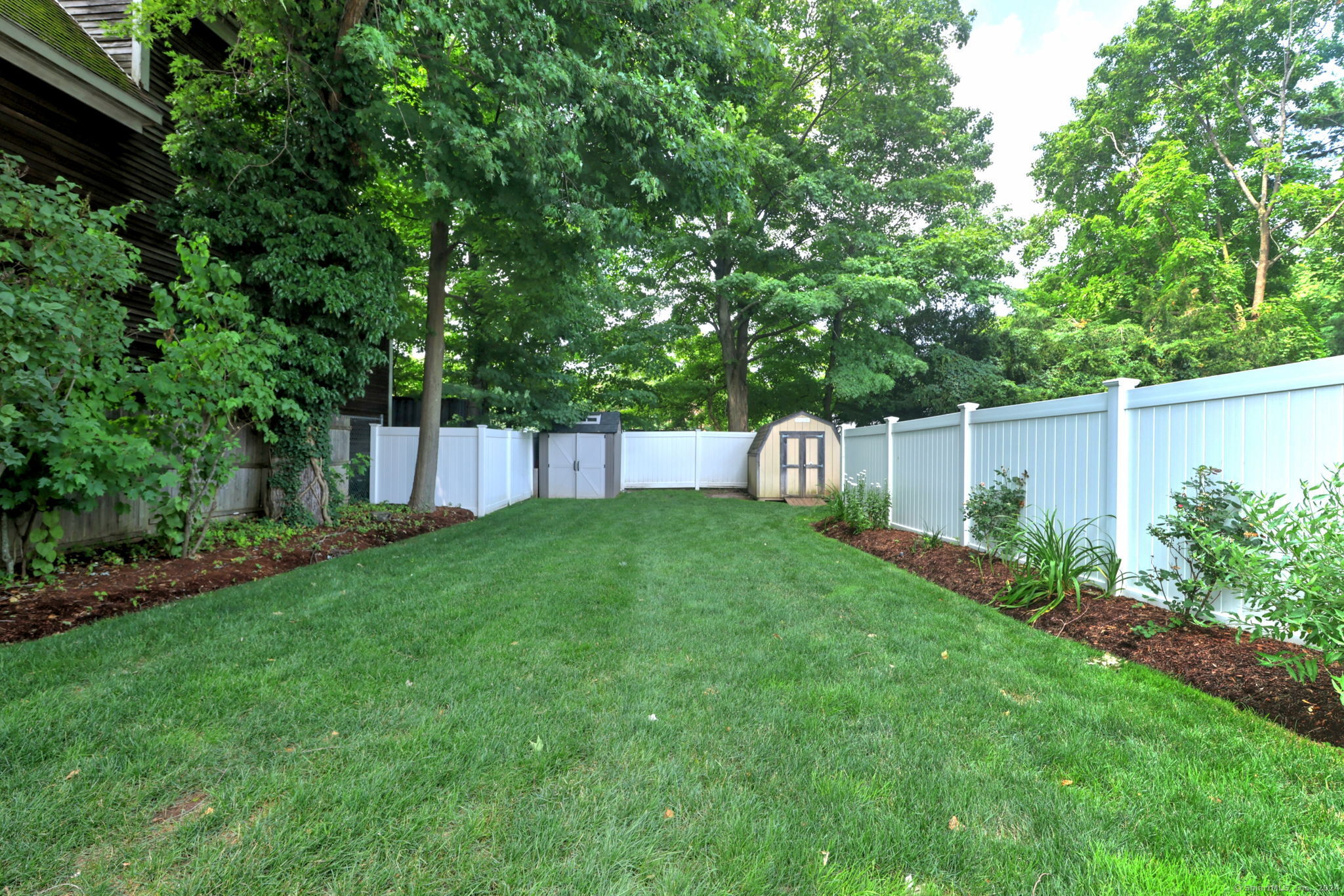 18 Day Spring Avenue Hamden, CT 06518 - Photo 4 of 35 The yard is fenced and offers plenty of space for entertaining and play! Two sheds store everything! Landscaping and lawn was professionally installed and maintained.
