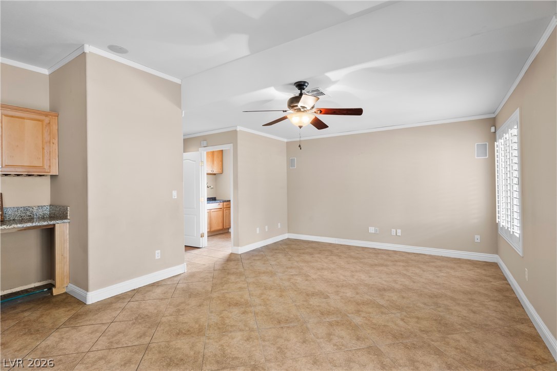 708 Vortex Avenue Henderson, NV 89002 - Photo 18 of 71 A tiled living space offers generous proportions and flows into a functional kitchen area.