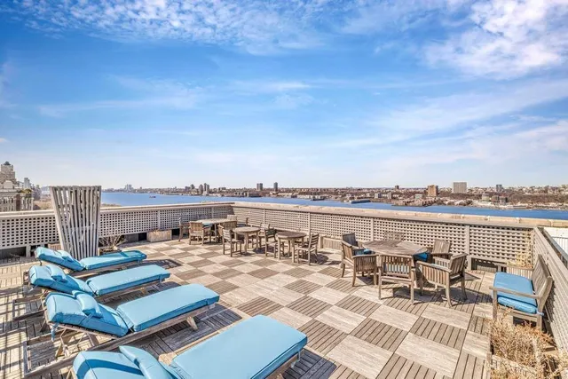 a living room with a large window and a rug