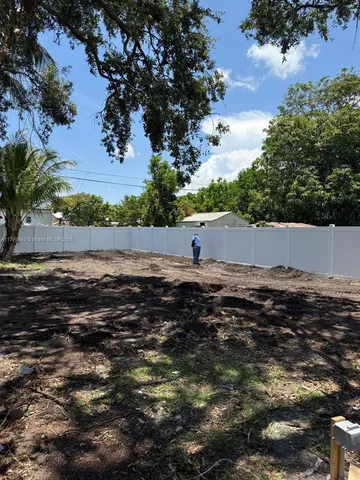 a view of a backyard with sitting area