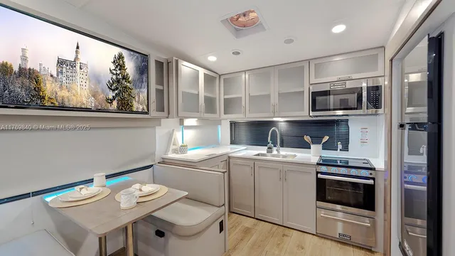 a kitchen with a sink cabinets and wooden floor