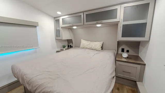 a bedroom with a bed and a ceiling fan