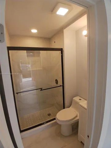 a bathroom with a toilet a sink and a shower