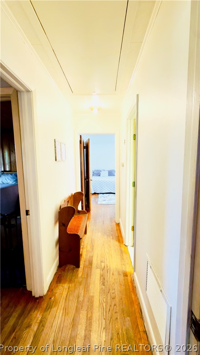 5309 Tobacco Road Orrum, NC 28369 - Photo 20 of 44 a large bedroom with a bed and wooden floor