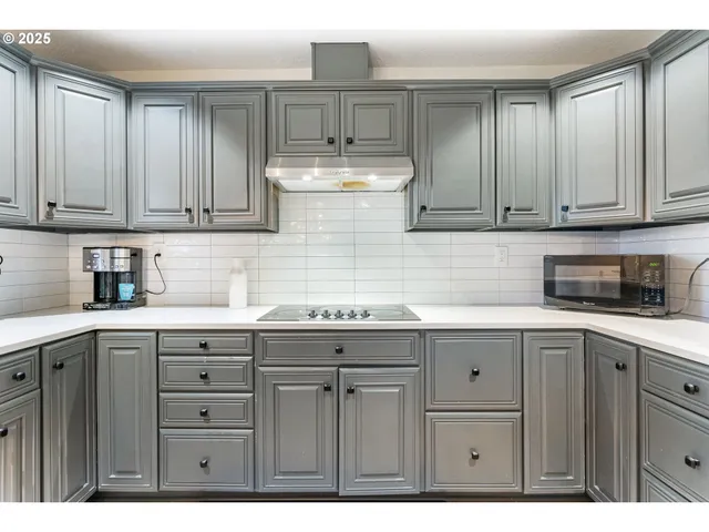 a kitchen with a sink and cabinets