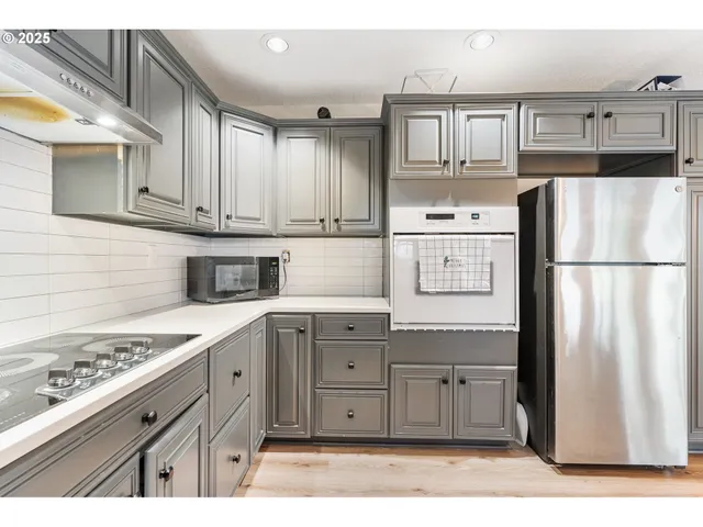 a kitchen with stainless steel appliances granite countertop a refrigerator sink and cabinets