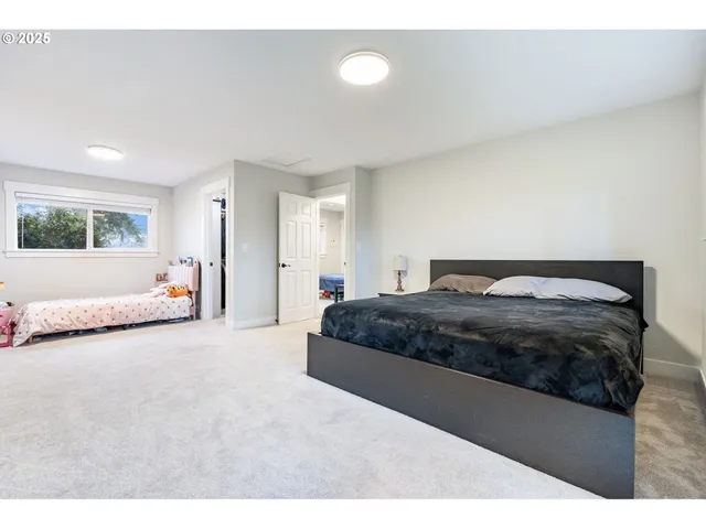 a bedroom with a large bed and a large window