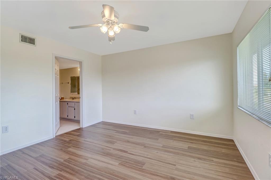 240 Pebble Beach Boulevard, Unit 710 Naples, FL 34113 - Photo 17 of 26 a view of empty room with wooden floor and fan