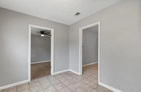 a view of an empty room and closet area