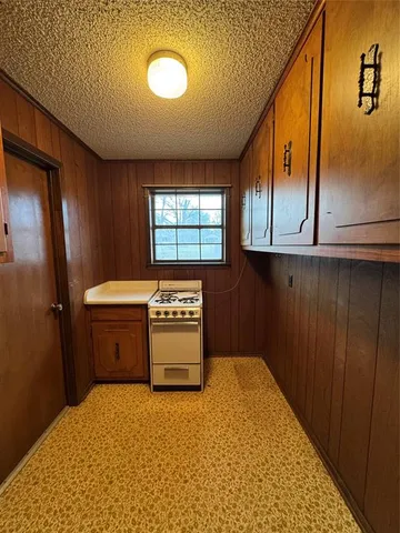 a spacious bathroom with a granite countertop sink and a bathtub