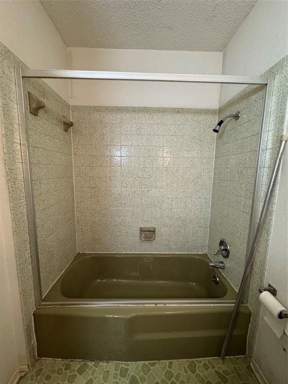 209 Harrison Avenue Roxton, TX 75477 - Photo 16 of 18 a bathroom with a shower and a bath tub