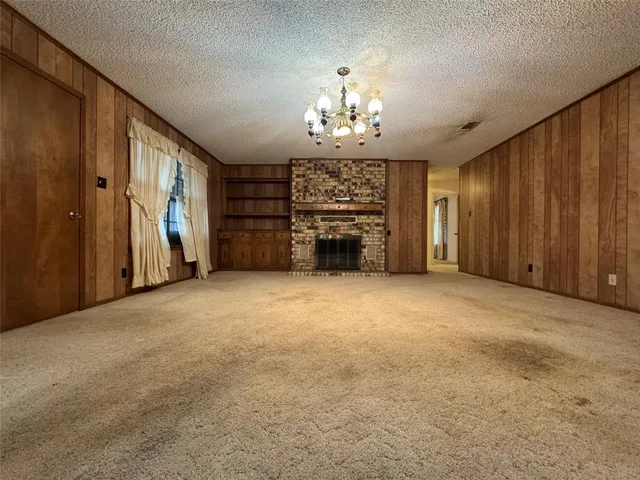 an empty room with furniture and a chandelier