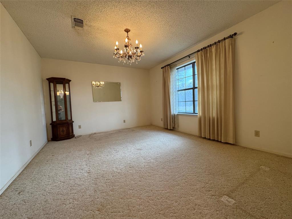 209 Harrison Avenue Roxton, TX 75477 - Photo 3 of 18 a view of an empty room with a window