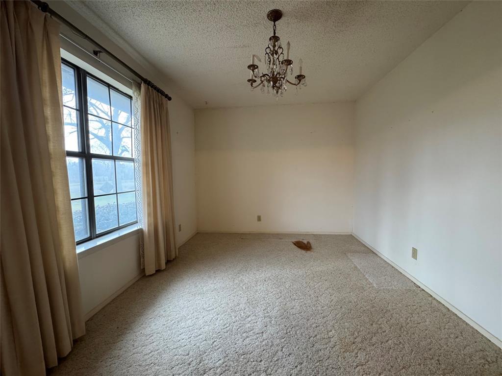 209 Harrison Avenue Roxton, TX 75477 - Photo 4 of 18 an empty room with a window
