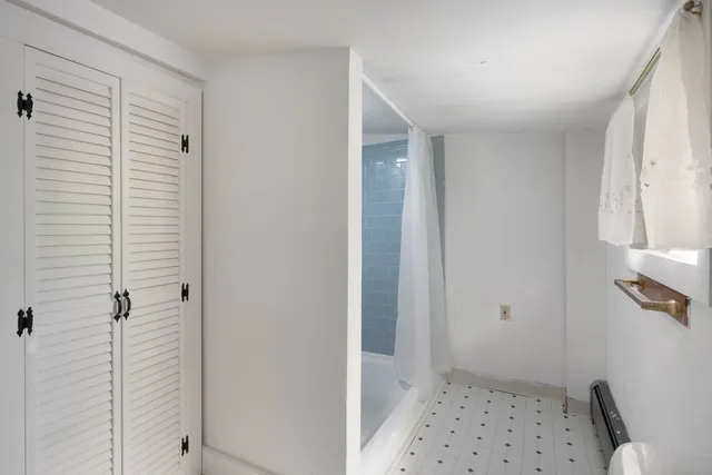 a bathroom with a shower and a toilet