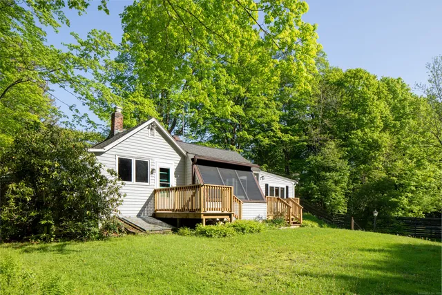 a front view of a house with a yard and trees
