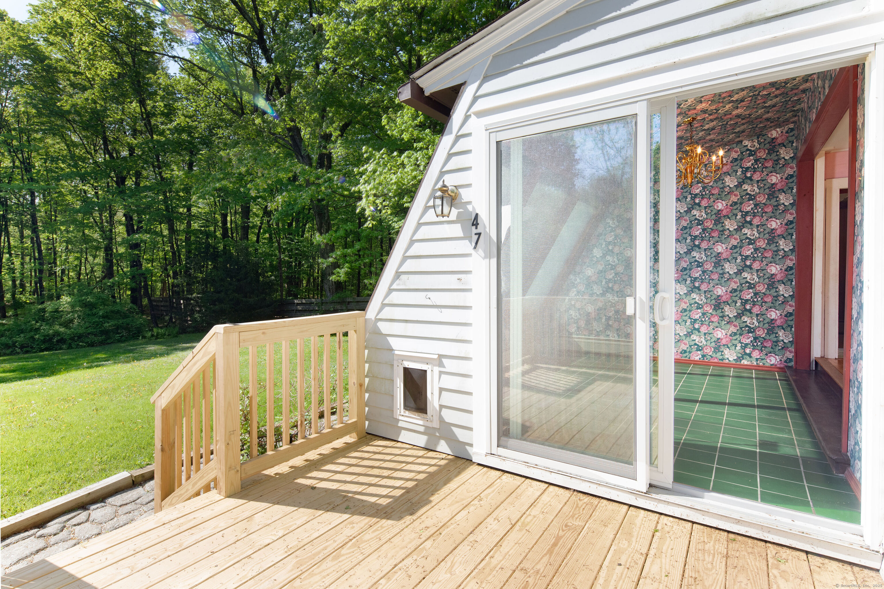 47 East Main Street Salisbury, CT 06068 - Photo 6 of 27 a view of a balcony with a floor to ceiling window and wooden fence