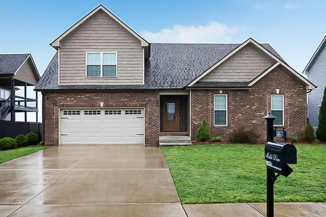 a front view of a house with a yard and garage