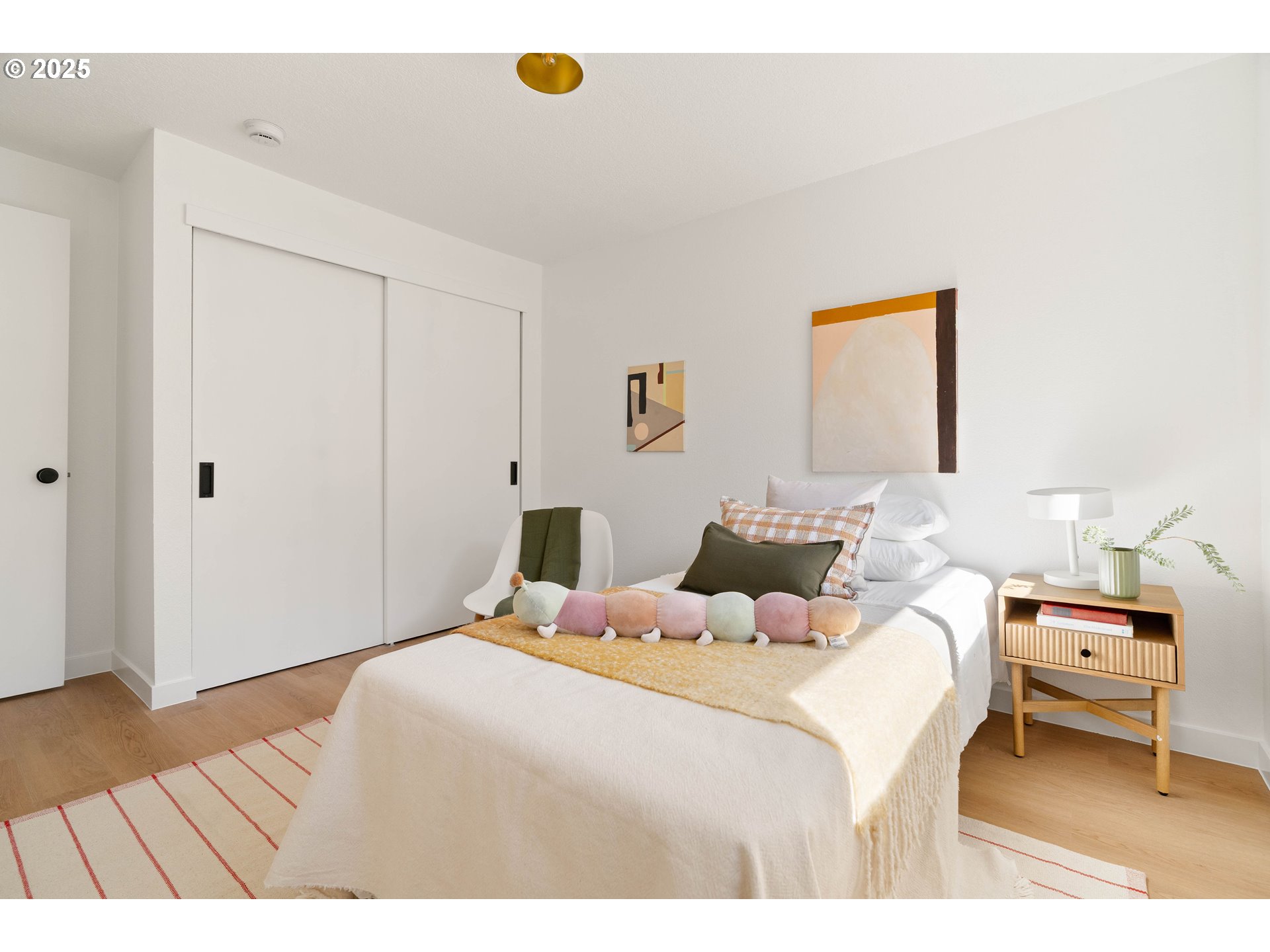 10904 Southwest 62nd Place Portland, OR 97219 - Photo 22 of 27 a bedroom with a bed and a wooden floor