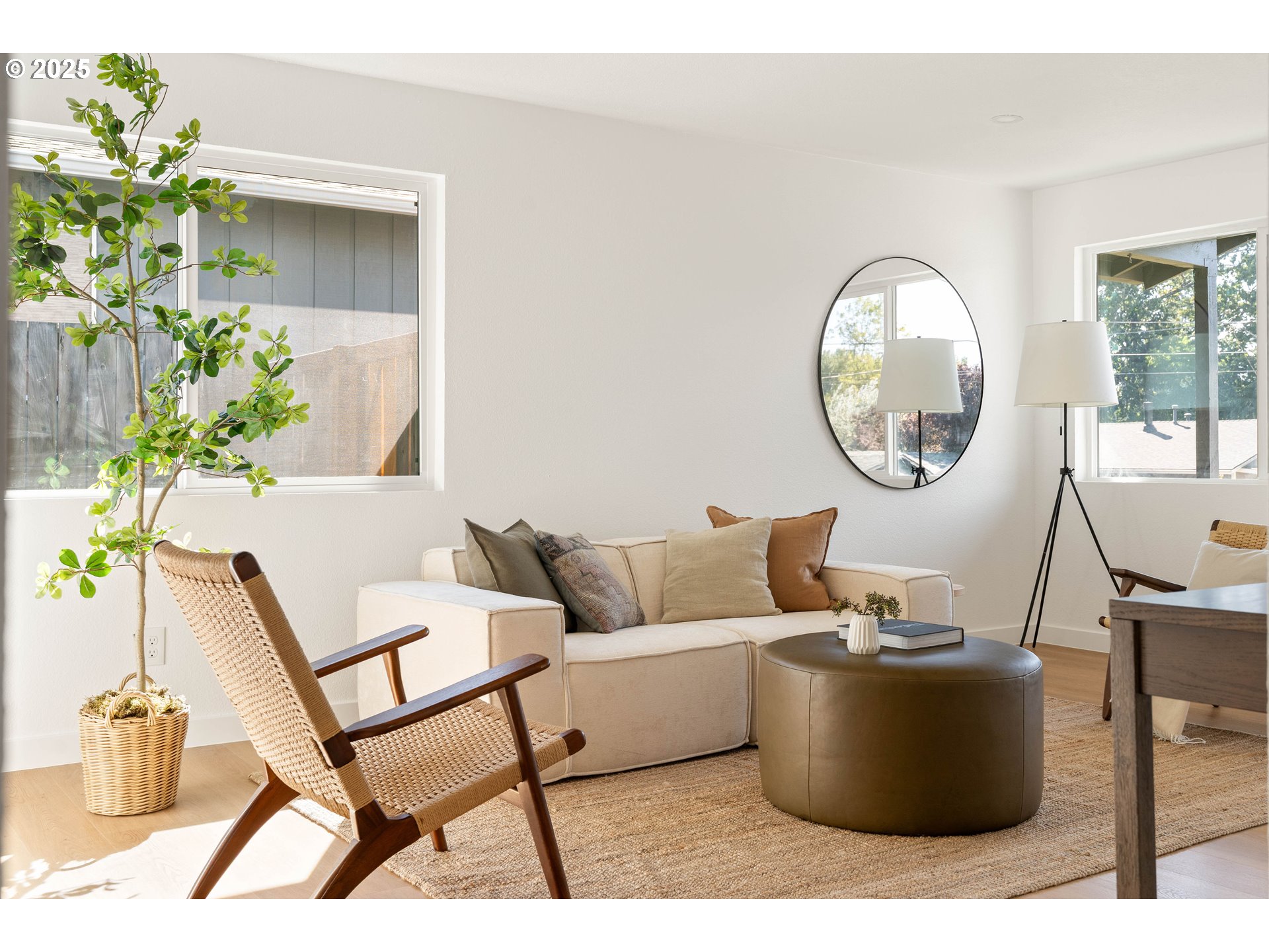 10904 Southwest 62nd Place Portland, OR 97219 - Photo 5 of 27 a living room with couches a mirror and a potted plant