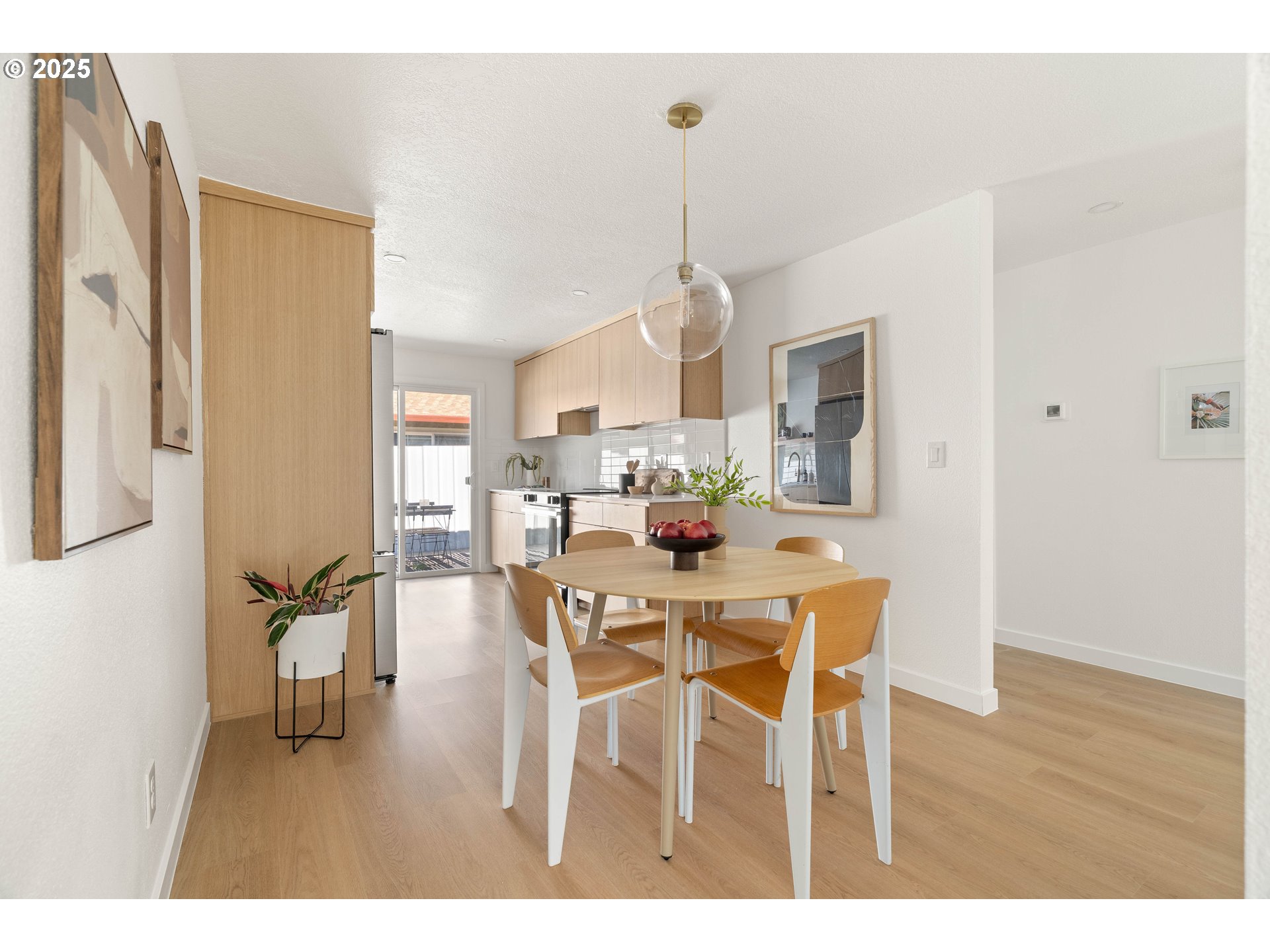 10904 Southwest 62nd Place Portland, OR 97219 - Photo 6 of 27 a dining room with furniture a chandelier and wooden floor