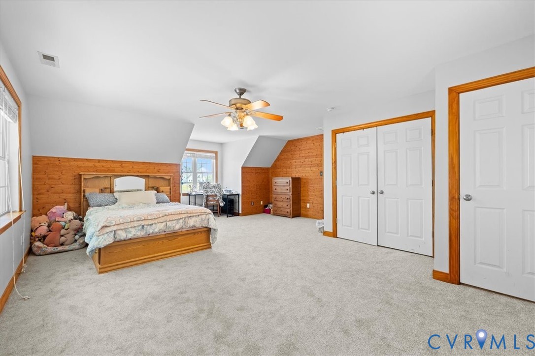 3137 Trenholm Road Powhatan, VA 23139 - Photo 36 of 72 a spacious bedroom with a bed and a chandelier