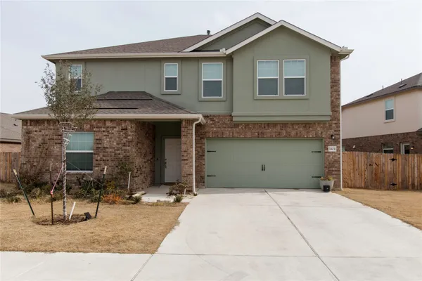 a front view of a house with garage