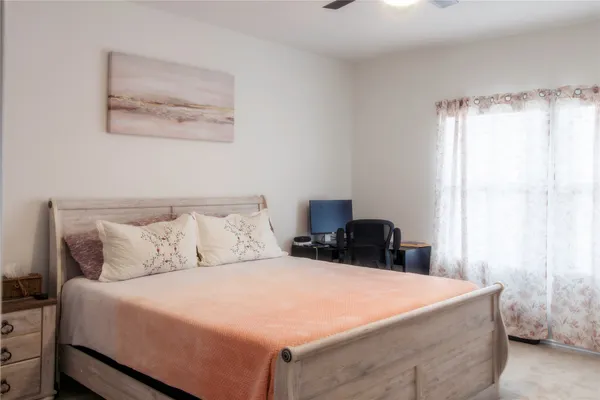 a bedroom with a bed and a painting on the wall