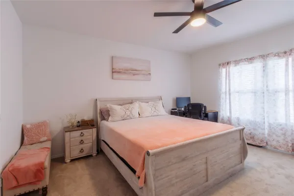a bedroom with a bed and a window
