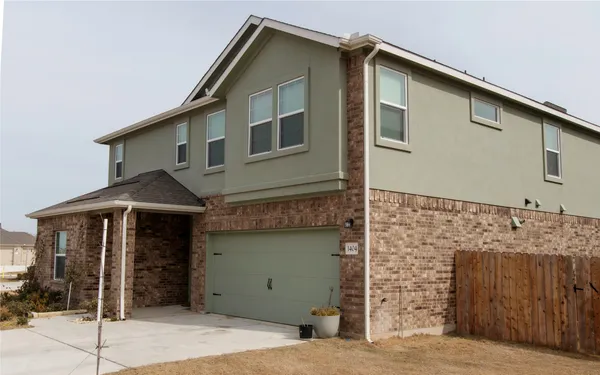 a front view of a house with garage