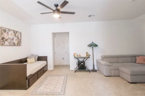 a living room with furniture and white walls