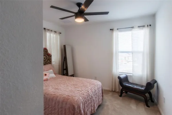 a bedroom with a bed and a mirror