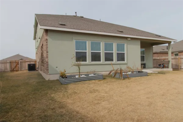 a view of a house with backyard and porch