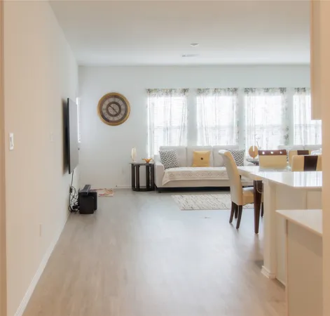 a living room with couches and a large window with outer view