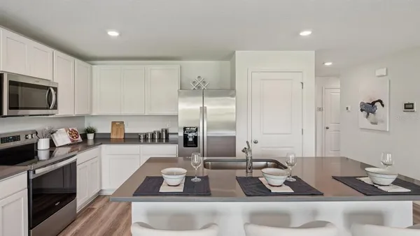 a kitchen with sink a stove and cabinets